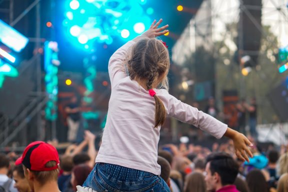Young girl on parent's shoulders